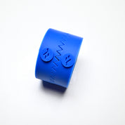 Blue silicone Fan Press pastry mold with a zigzag seam and circular logo details.