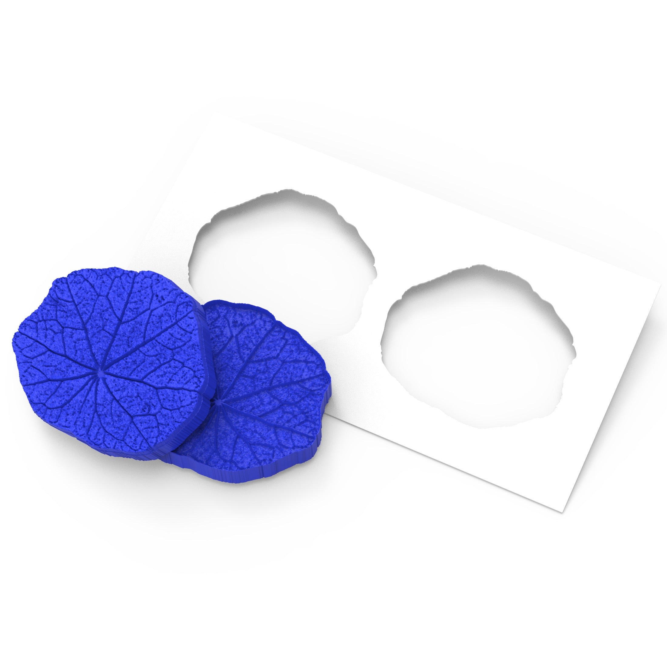 Blue nasturtium leaf silicone pastry molds with detailed vein textures and a white stencil.