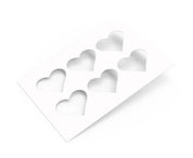 White TBmolds pastry stencil with six heart-shaped cutouts for decorating desserts.