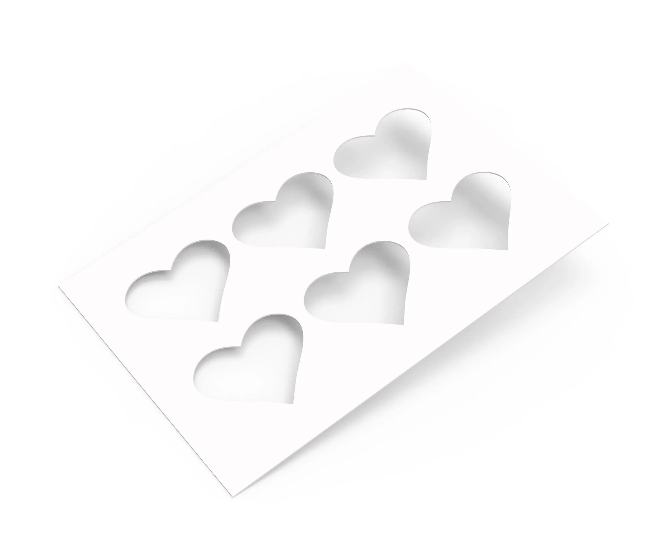 White TBmolds pastry stencil with six heart-shaped cutouts for decorating desserts.