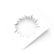 White square pastry stencil featuring a cutout sun shape with wavy, flame-like rays.