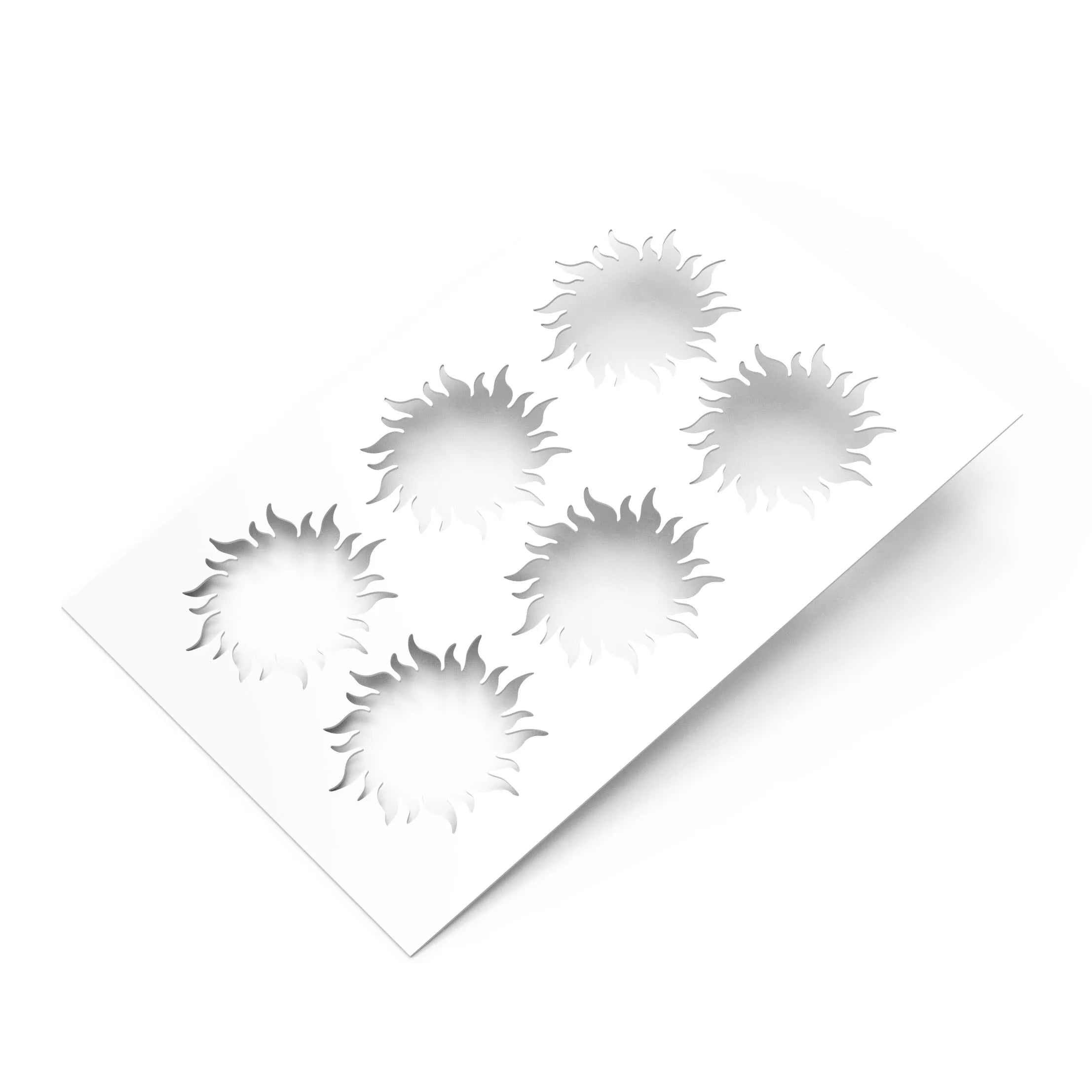 White plastic pastry stencil featuring six sun-shaped cutouts with wavy rays.