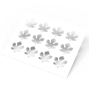 White plastic pastry stencil featuring twelve detailed fig leaf cutouts.