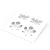 White plastic pastry stencil featuring four detailed fig leaf cutouts.