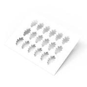 White plastic pastry stencil featuring multiple oak leaf shaped cutouts.