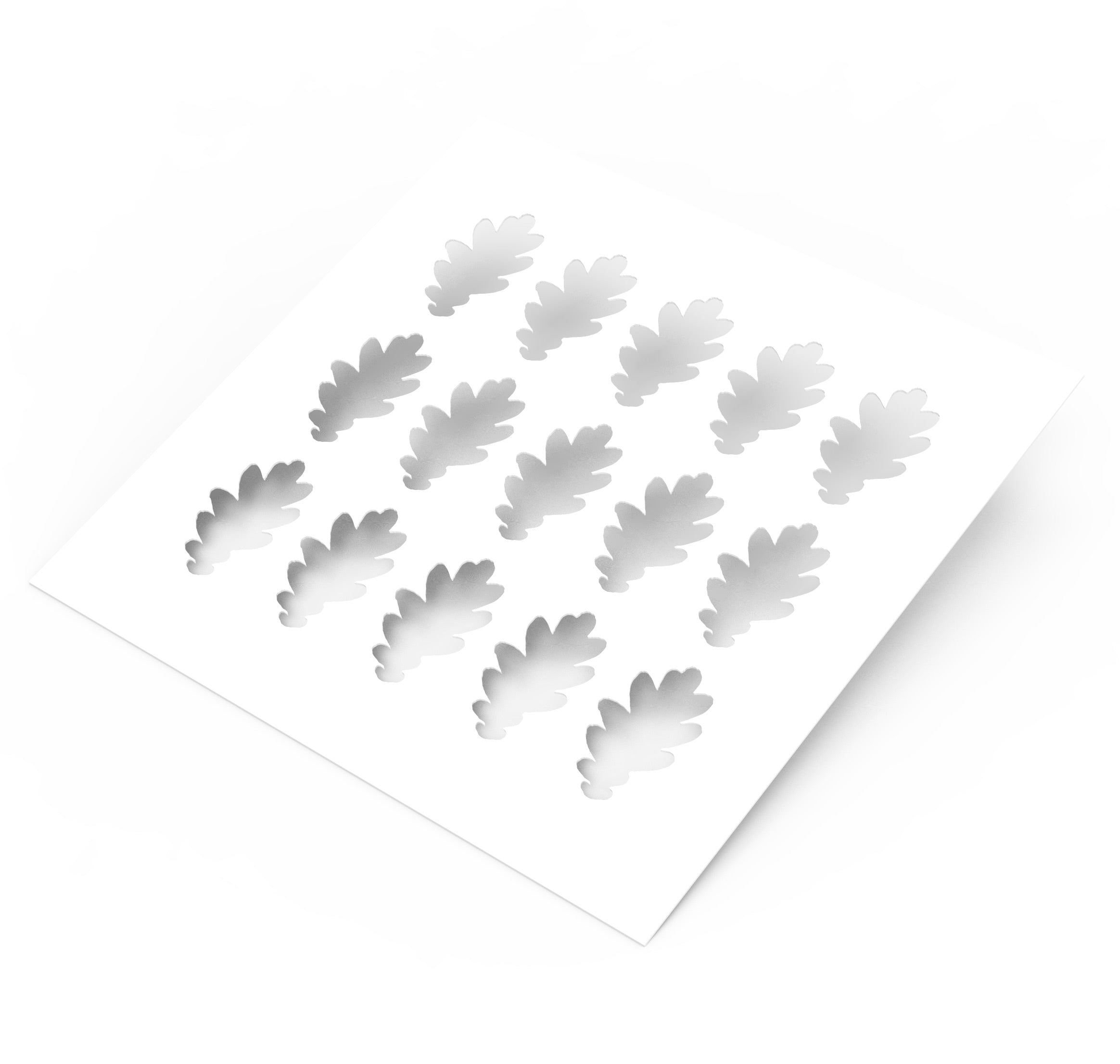 White plastic pastry stencil featuring fifteen detailed oak leaf cutouts.