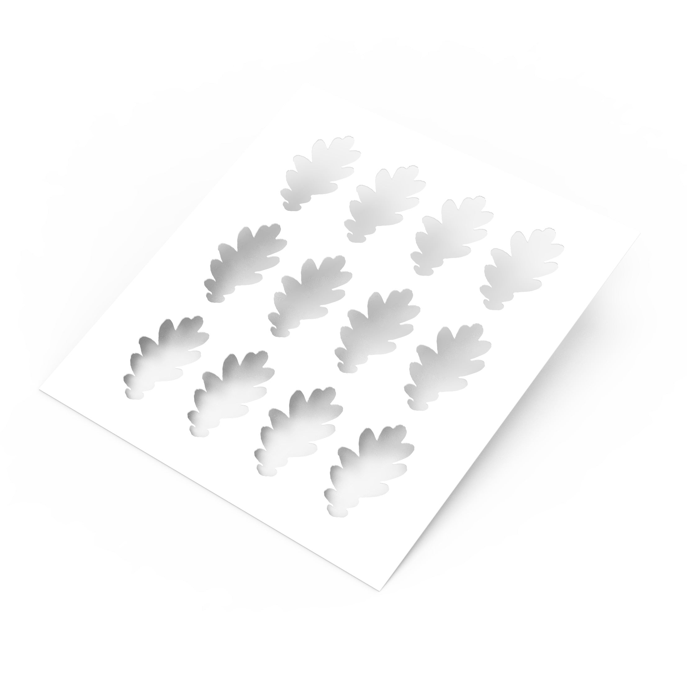 White plastic pastry stencil featuring twelve detailed oak leaf cutouts.