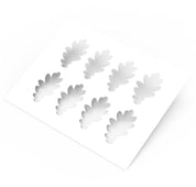 White plastic pastry stencil featuring eight detailed oak leaf cutouts.