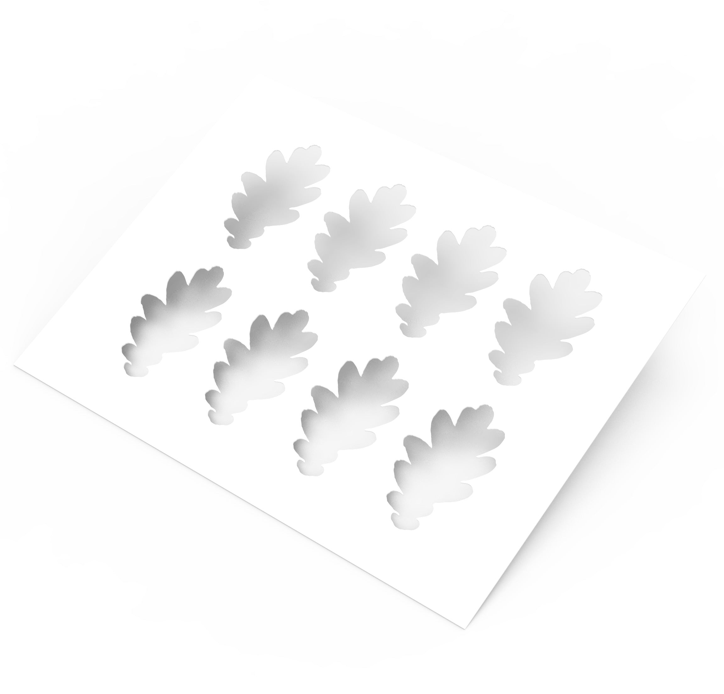 White plastic pastry stencil featuring eight detailed oak leaf cutouts.