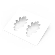 White plastic pastry stencil featuring two detailed oak leaf cutouts.