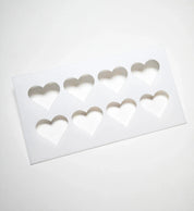 White rectangular pastry stencil featuring eight heart-shaped cutouts in two rows.