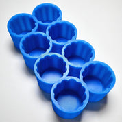 Blue silicone Mini Charlotte mold with eight fluted, round dessert cavities.