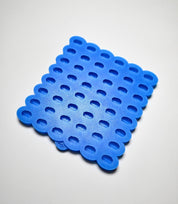 Blue silicone mini coffee bean mold with multiple small, oval-shaped cavities.