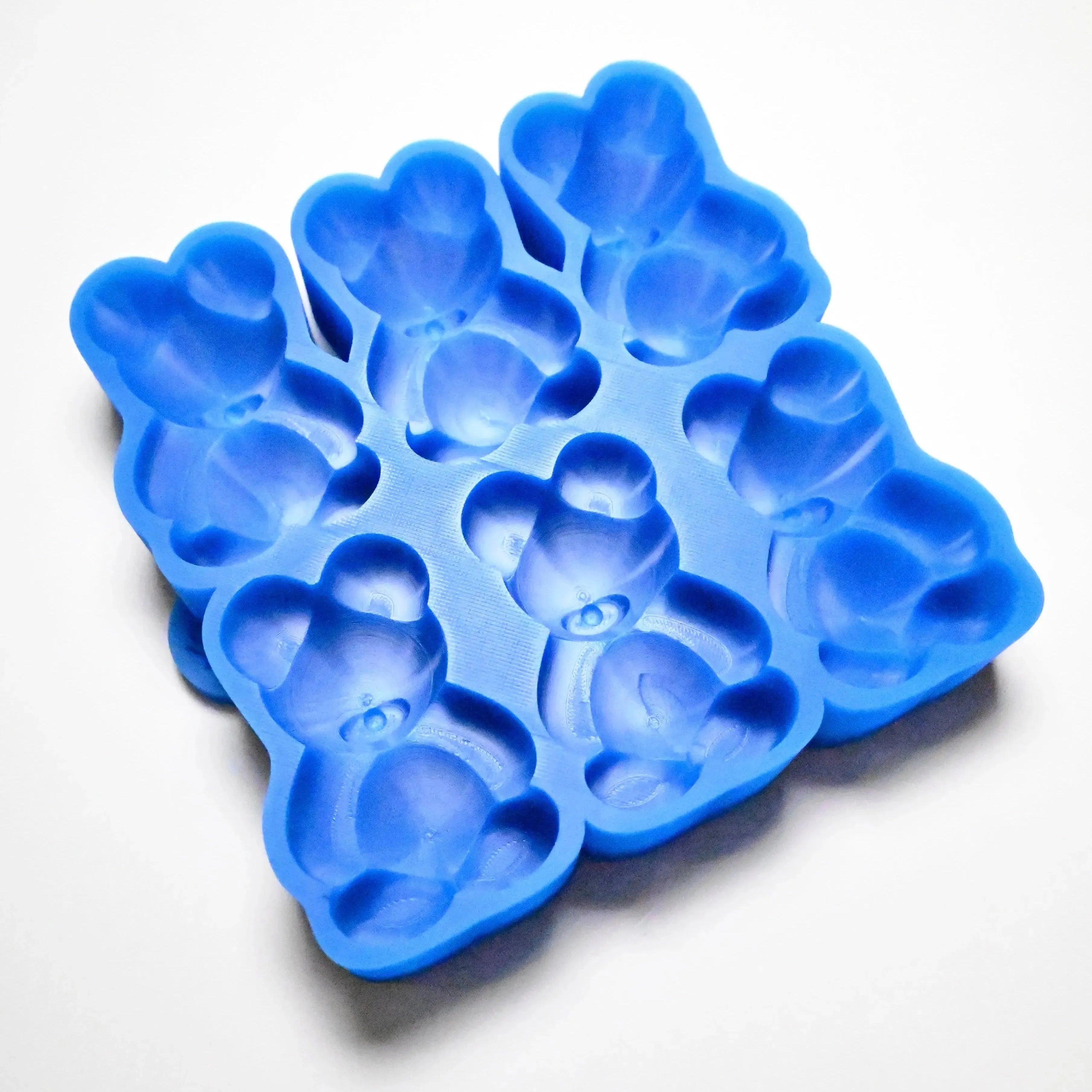 Blue silicone mold with six detailed bear-shaped cavities for baking and chocolate making.