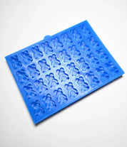 Blue silicone baking mold with multiple detailed mini bear-shaped cavities.