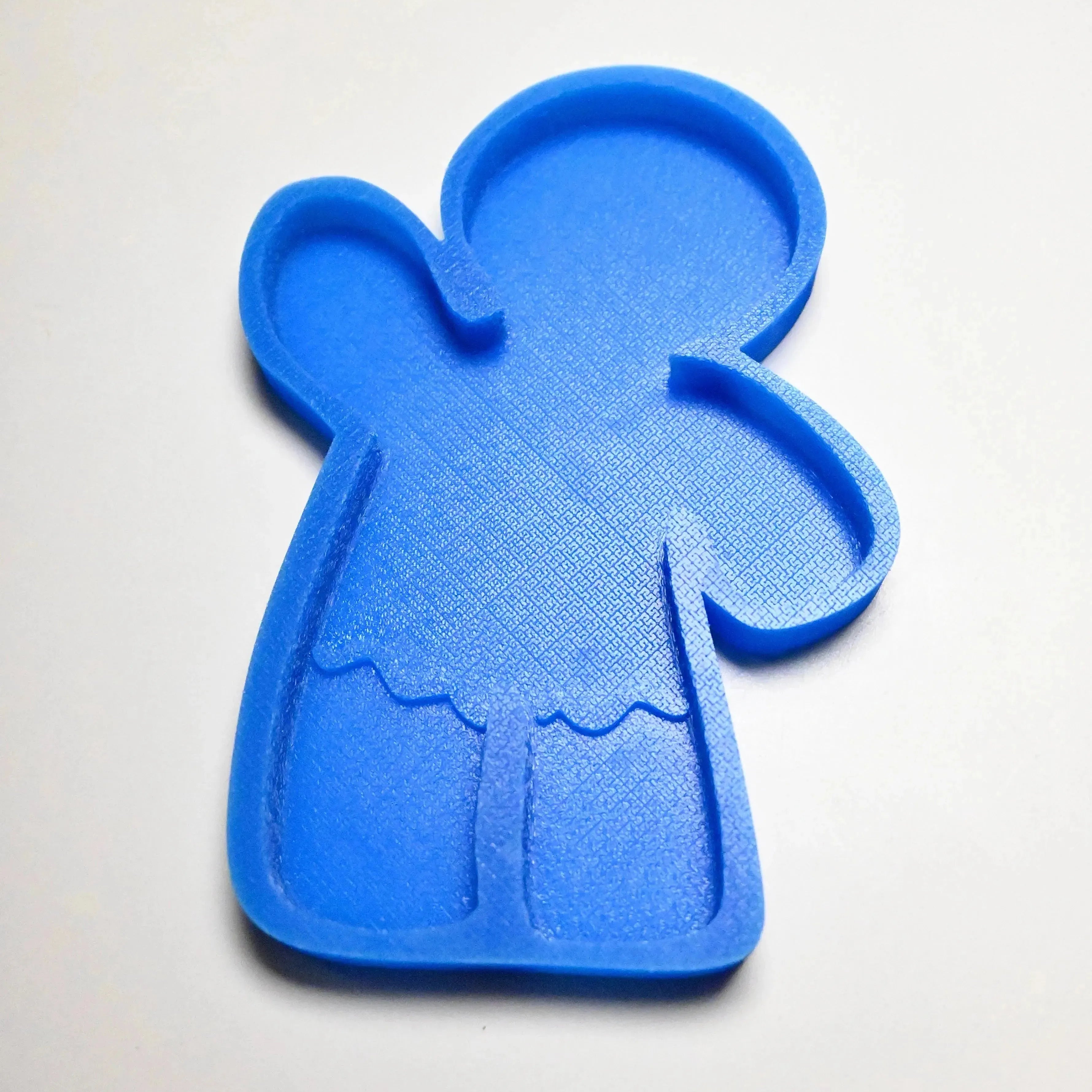Blue textured silicone gingerbread man mold with a waving arm design.