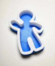Blue and white gingerbread man silicone mold with a textured base.