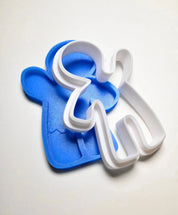 Blue gingerbread man silicone mold with a white plastic outline cutter.