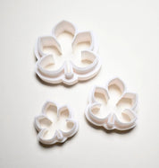 Three white plastic horse chestnut leaf cookie cutters in small, medium, and large sizes.
