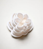 Stacked white plastic horse chestnut leaf cookie cutters in graduated sizes.
