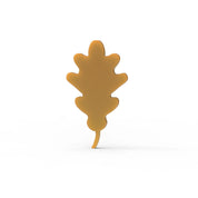 Golden brown oak leaf shaped tuile pastry on a plain white background.