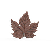 Detailed brown chocolate vine leaf with intricate vein textures, molded from a silicone pastry mold.