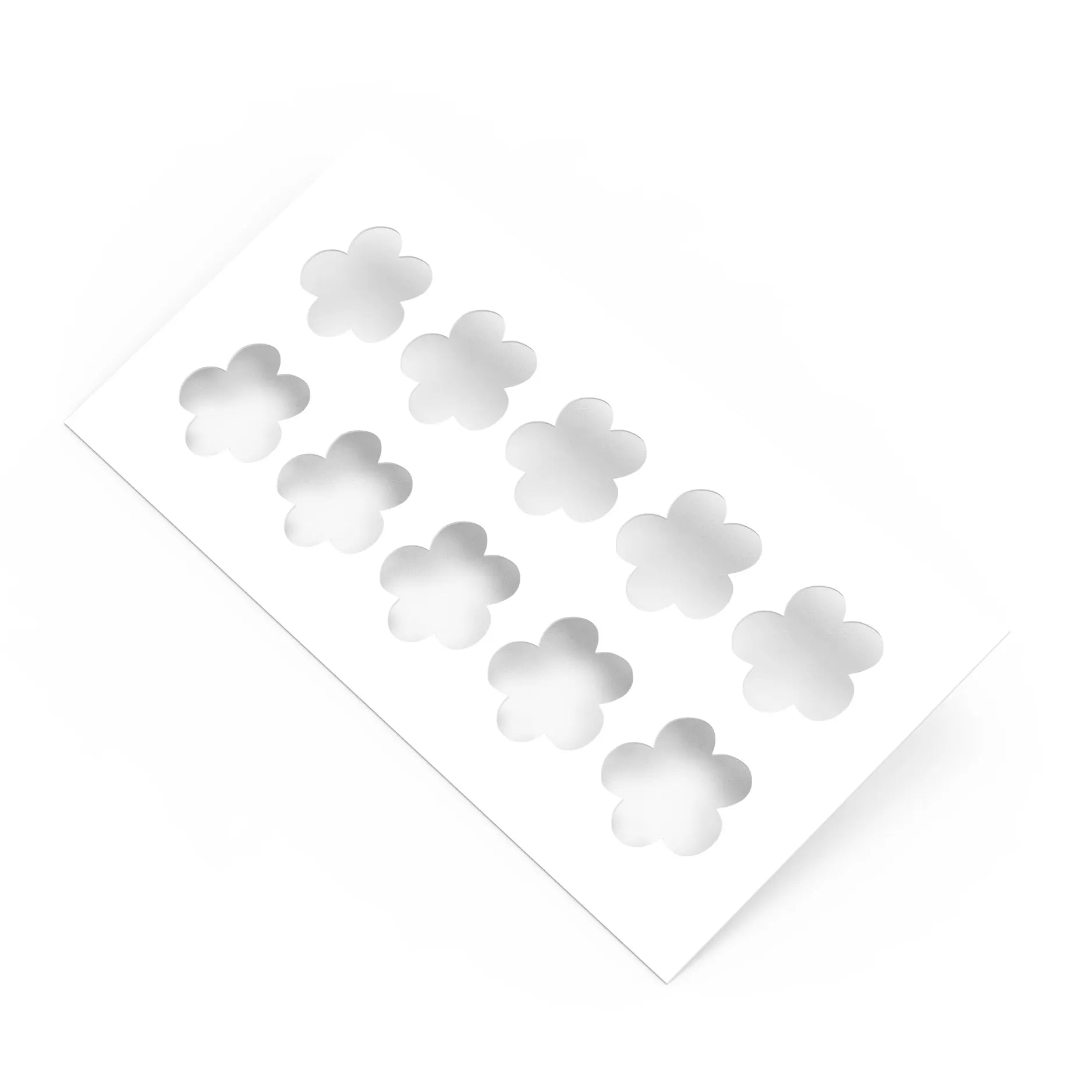 White plastic pastry stencil with ten five-petal strawberry flower cutouts.