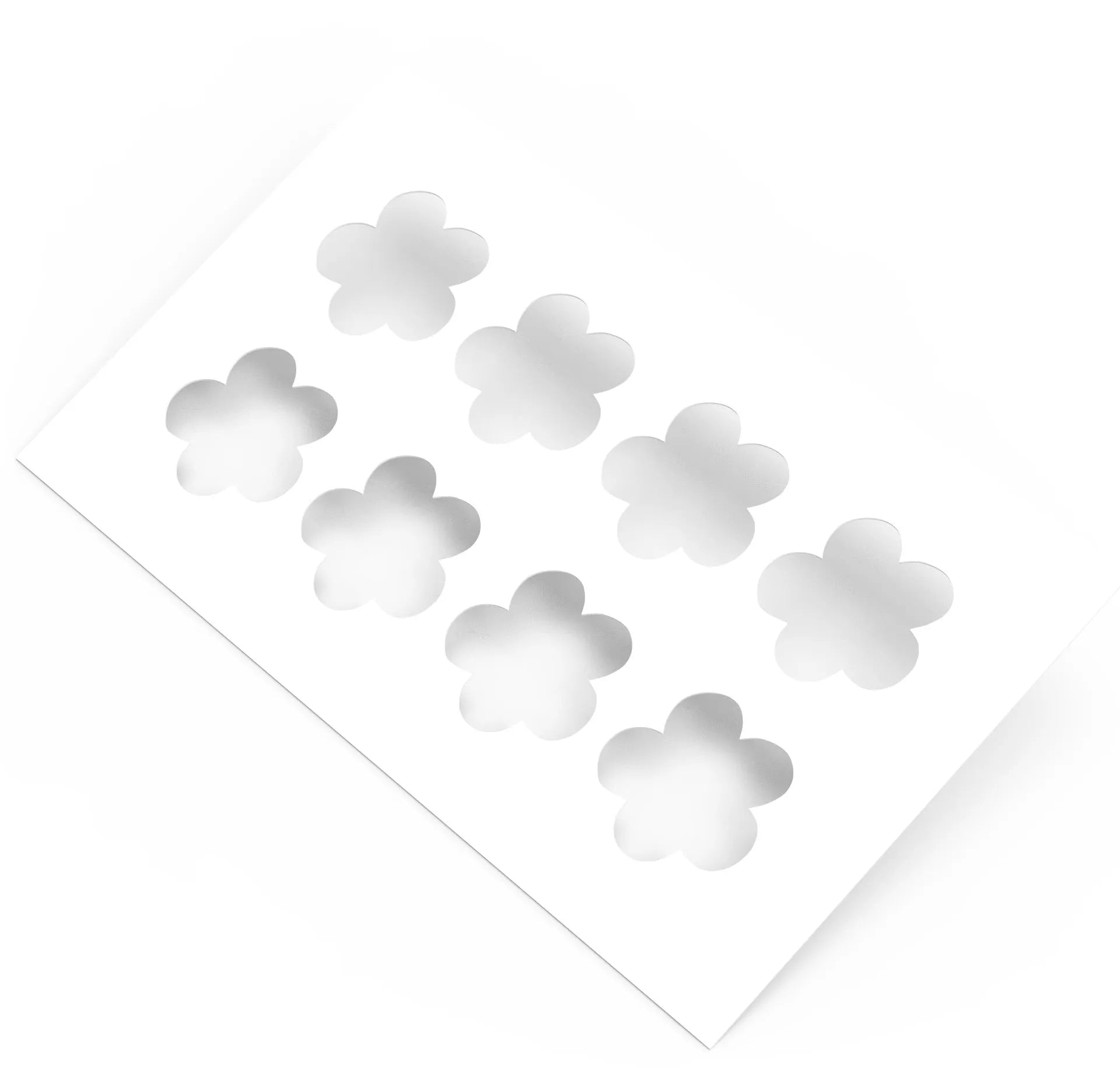 White plastic pastry stencil with eight five-petal strawberry flower cutouts.