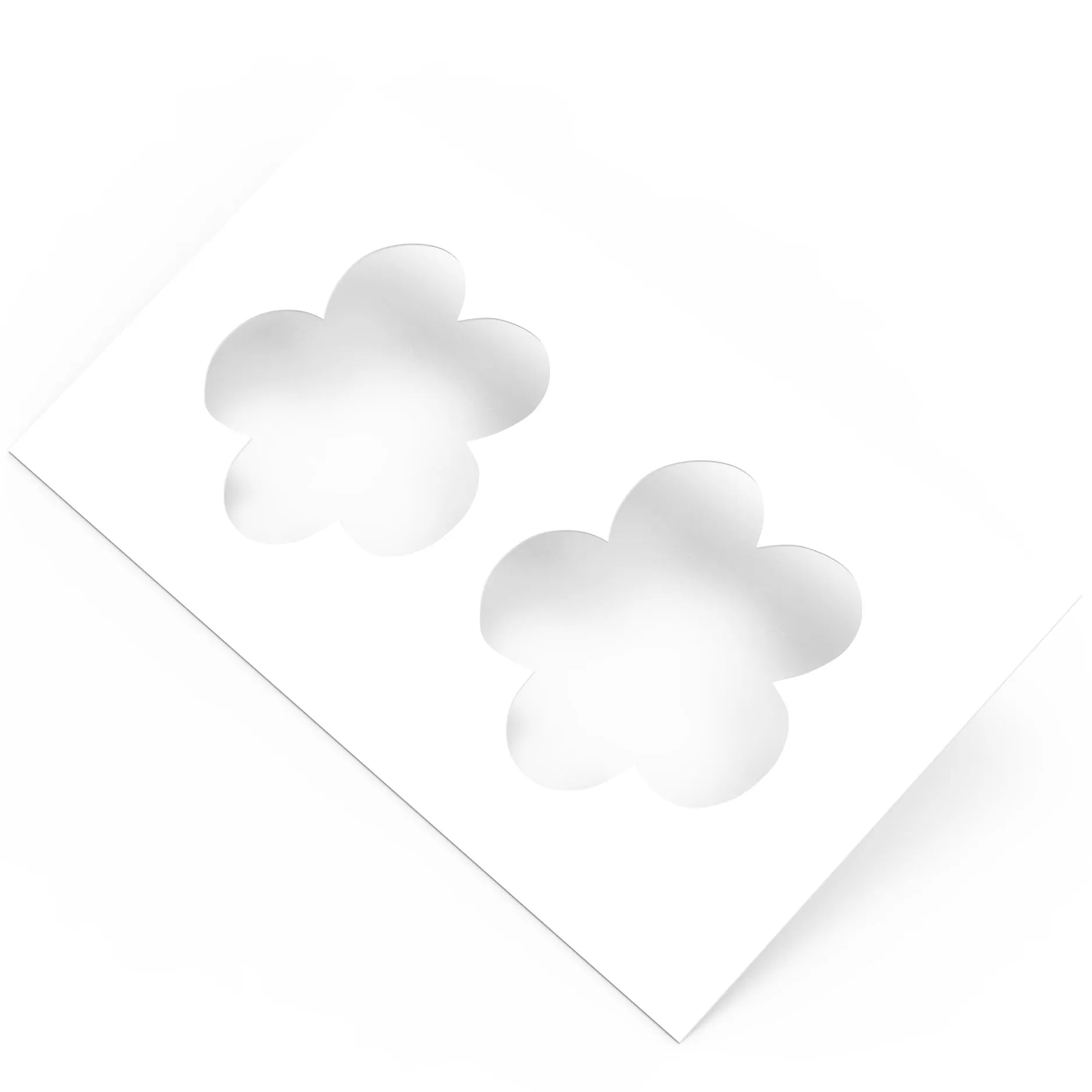 White plastic pastry stencil with two five-petal strawberry flower cutouts.