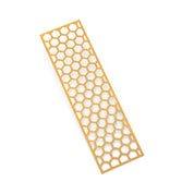 Yellow silicone tuile mat with a long, rectangular honeycomb pattern of open hexagonal molds.
