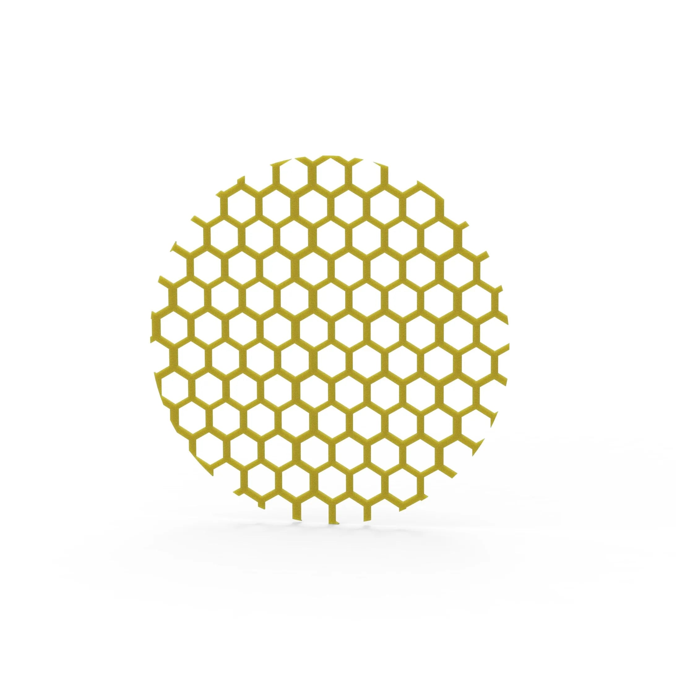 Yellow circular silicone tuile mat with a precise hexagonal honeycomb pattern.