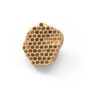 Beige silicone mold in the shape of an irregular, realistic honeycomb fragment.