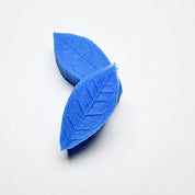 Blue silicone tea leaf press molds showing detailed leaf vein textures on a white background.