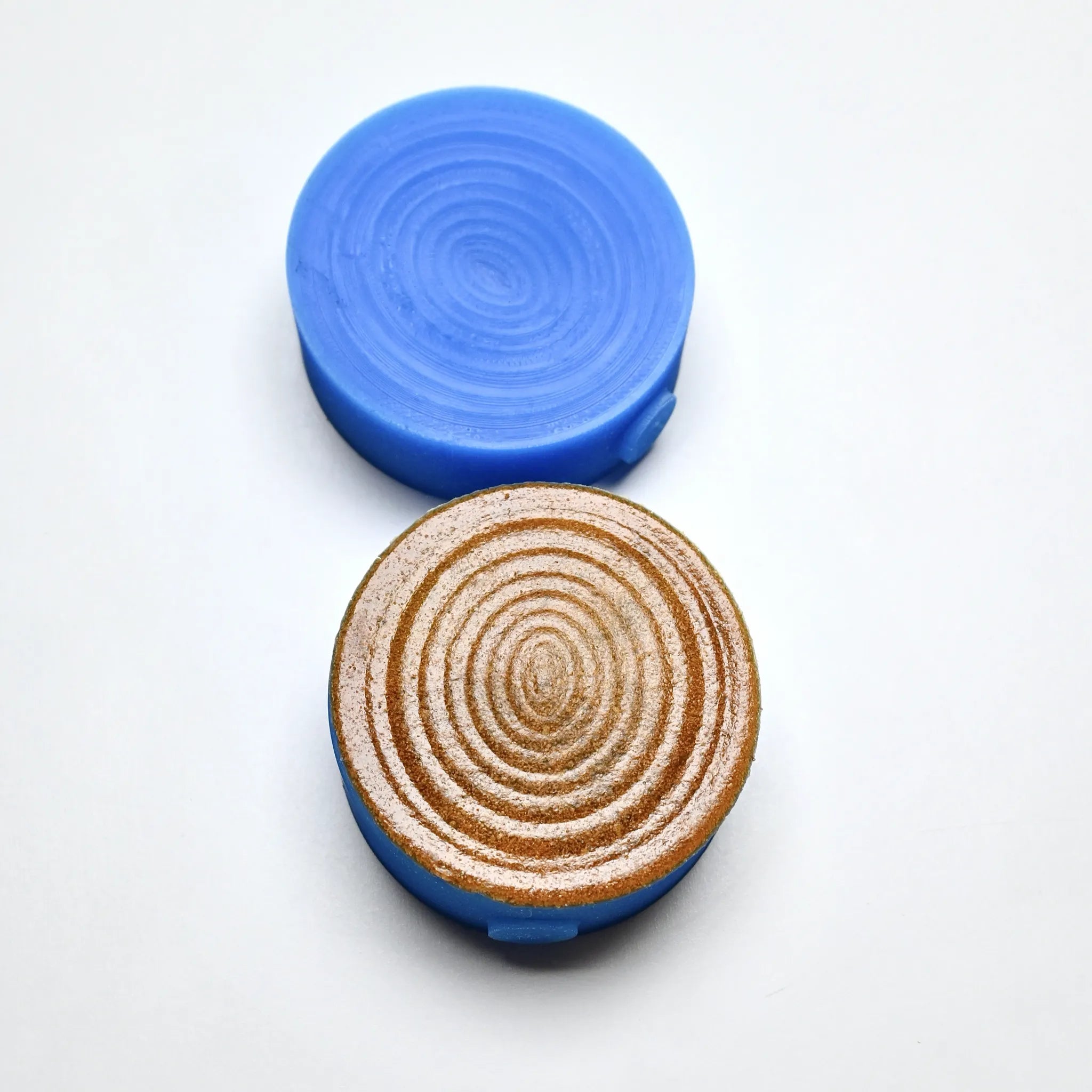 Blue silicone Resonance pastry press showing concentric oval textured molds.