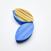 Blue silicone wavy calisson molds with a textured gold leaf-shaped pastry element.