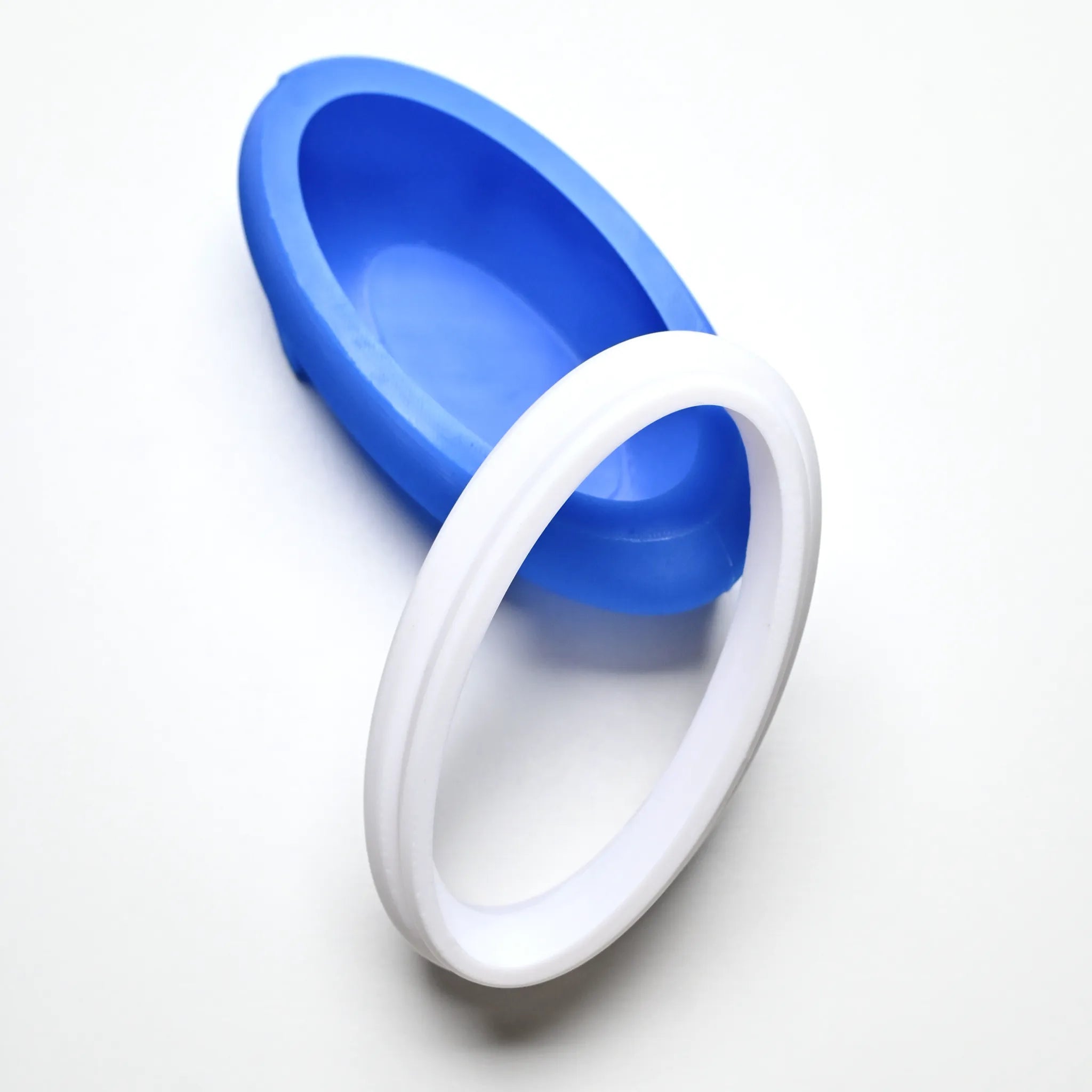 Blue silicone ellipse mold with a matching white plastic cutting ring.