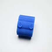 Blue silicone Helios pastry press with a cylindrical shape and textured chevron patterns.