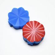 Blue and red Helios silicone pastry presses with a scalloped, radiant sunburst design.