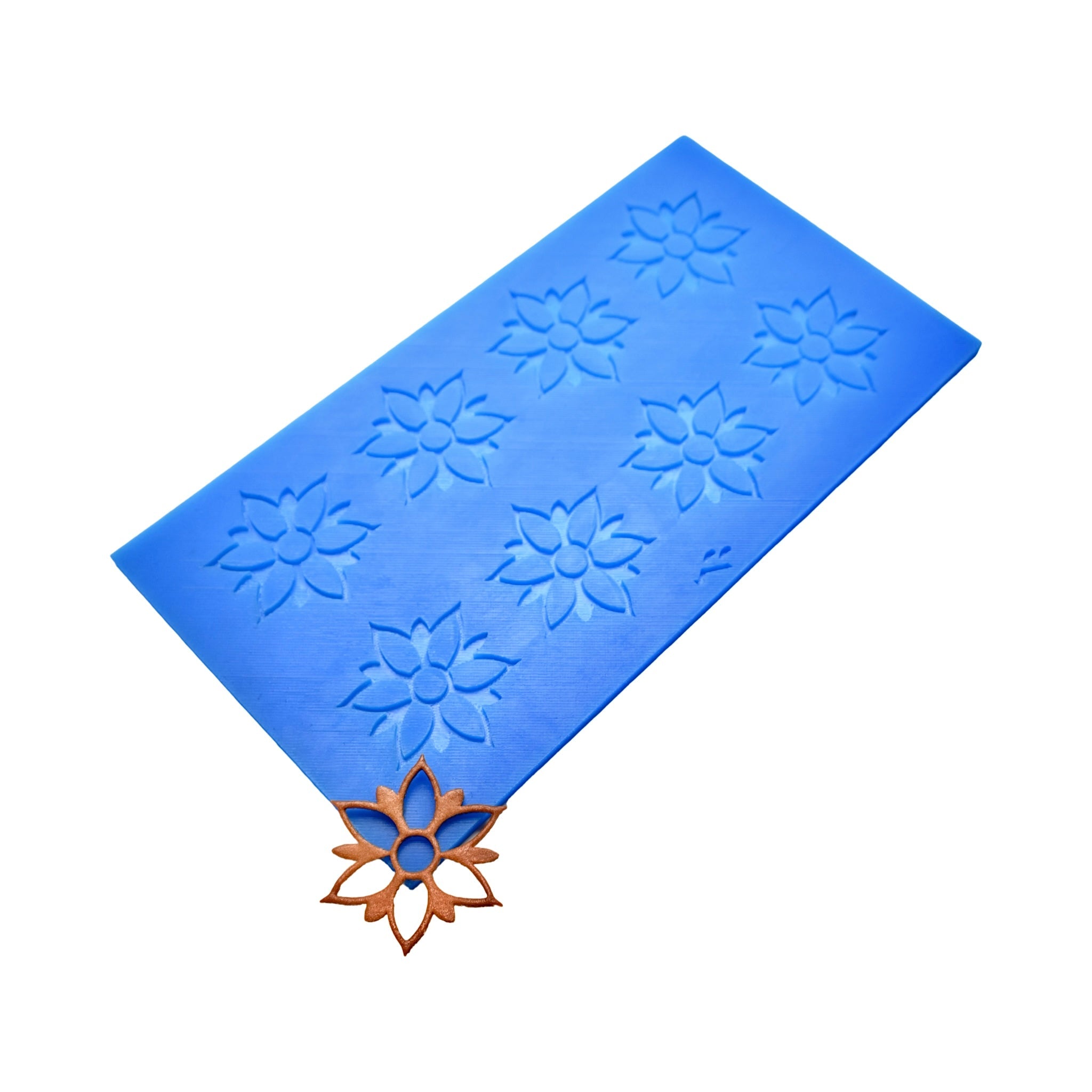 Blue Onalia silicone tuile mat with flower-shaped molds and a finished bronze tuile.