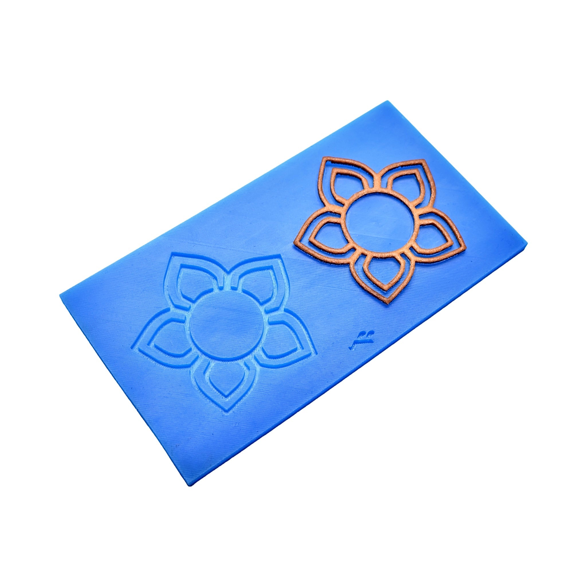 Blue Floris silicone mat with five-petal flower tuile molds and a bronze-colored baked tuile.