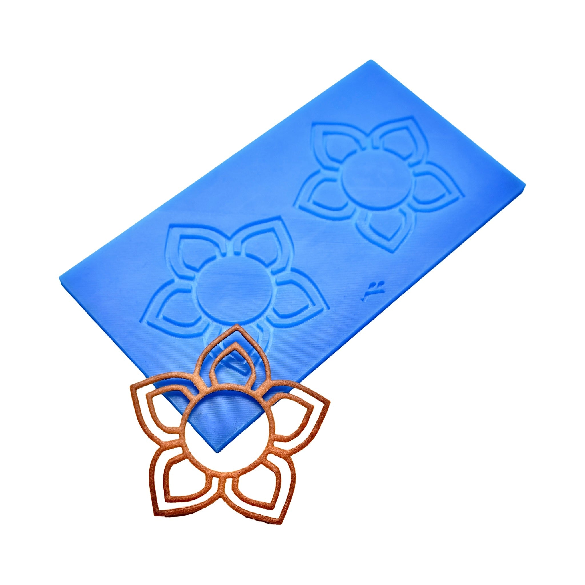 Blue silicone Floris tuile mat with five-petal flower molds and a bronze-colored baked tuile.