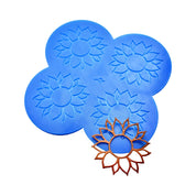 Blue sunflower tuile silicone mat with four flower-shaped molds and a baked golden tuile.