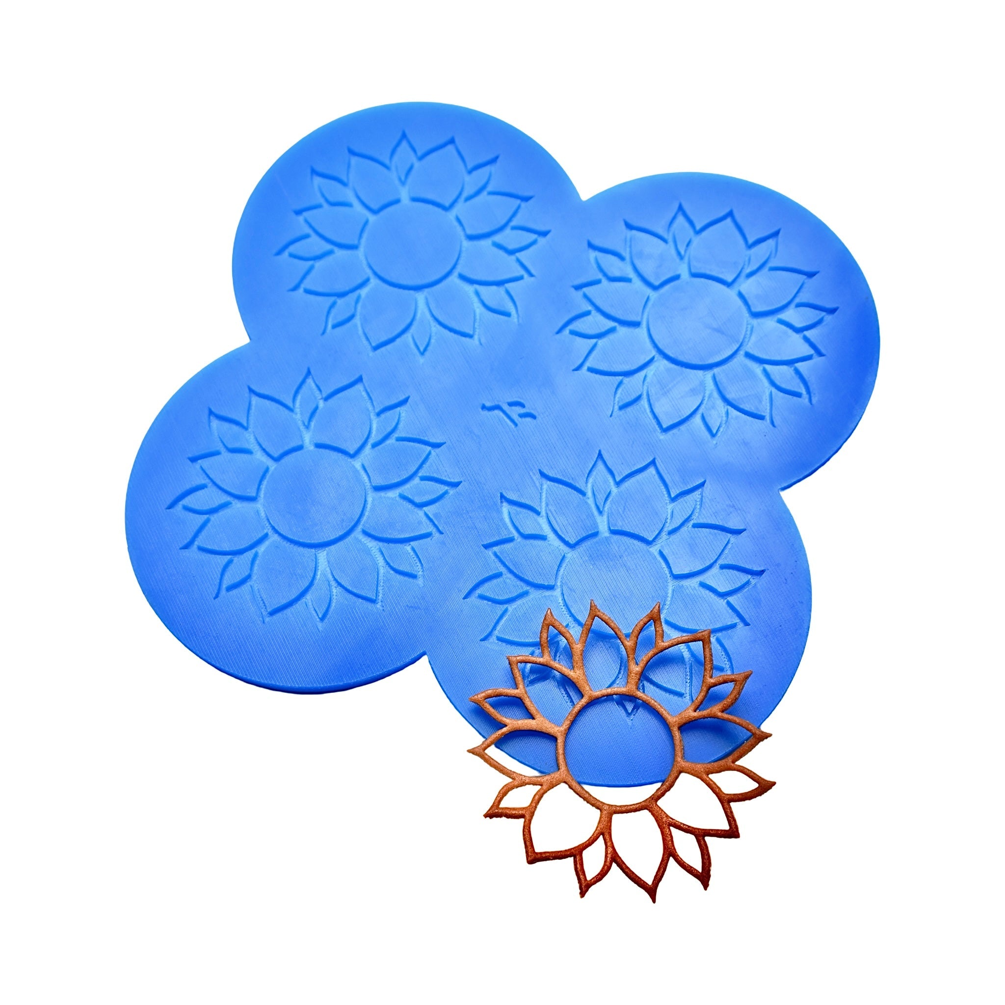 Blue sunflower tuile silicone mat with four flower-shaped molds and a baked golden tuile.