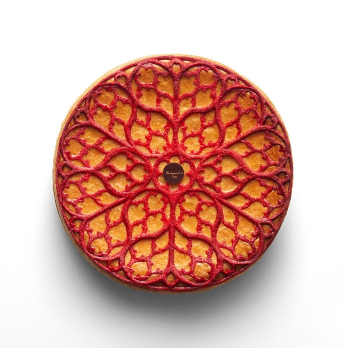 Intricate red gothic rosette tuile on a round pastry, made with the Regalia silicone mat.