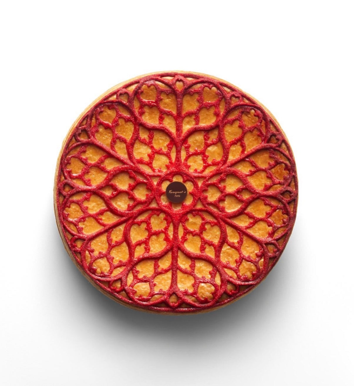 Intricate red gothic rosette tuile on a round pastry, made with the Regalia silicone mat.