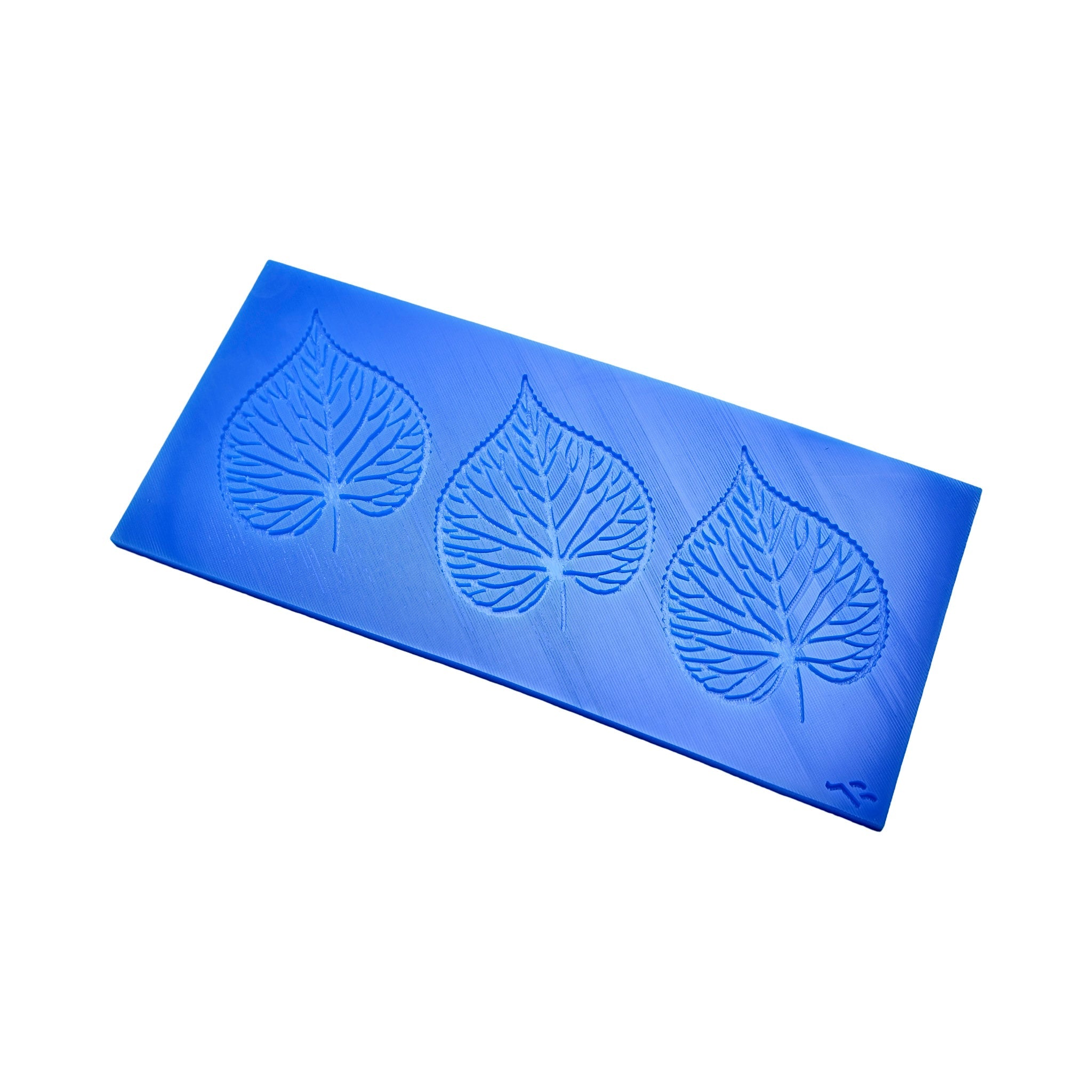 Blue silicone Tilia pastry mat with three detailed linden leaf tuile molds.