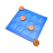 Blue silicone Linden leaf tuile mold with heart-shaped leaf cavities and baked golden tuiles.