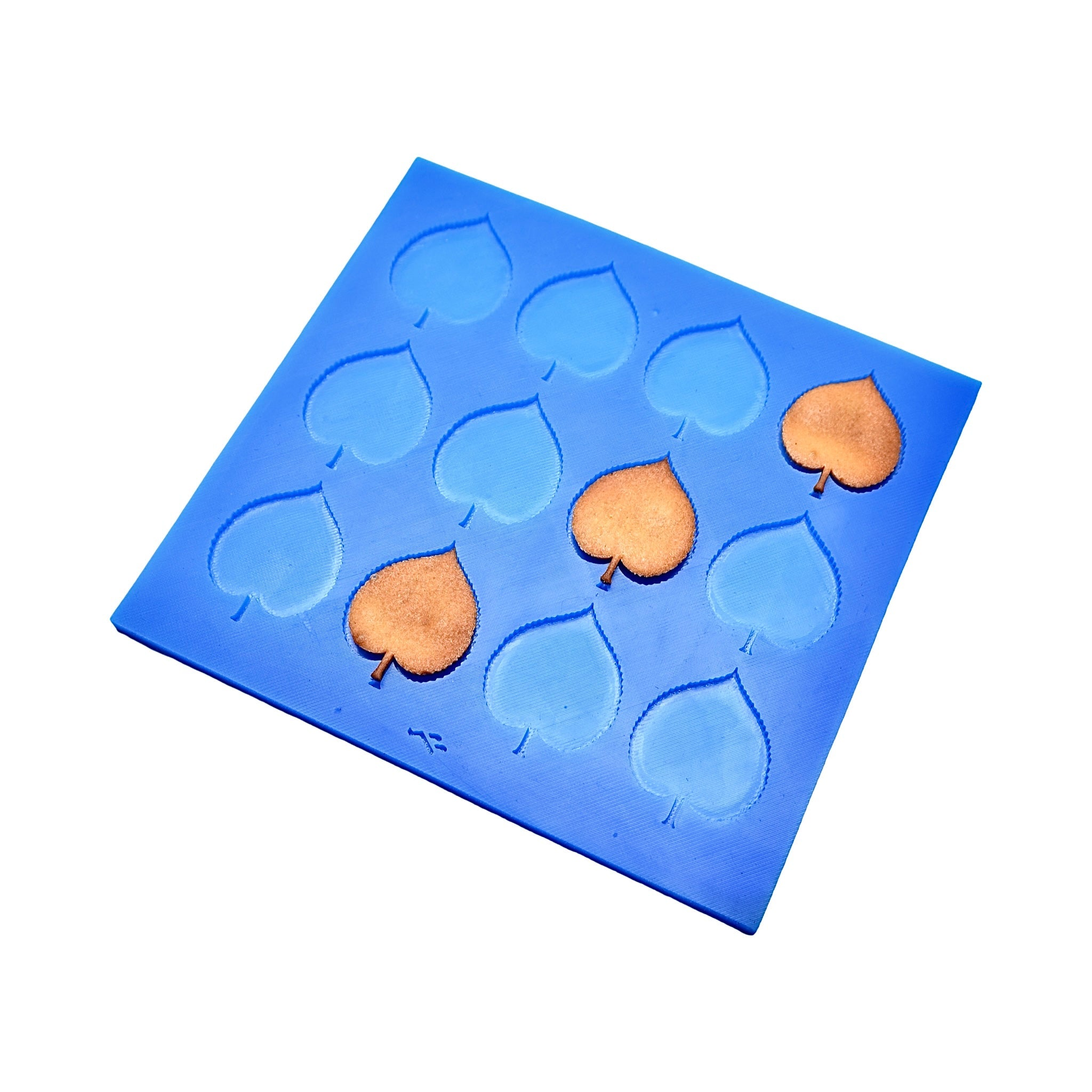 Blue silicone Linden leaf tuile mold with heart-shaped leaf cavities and baked golden tuiles.