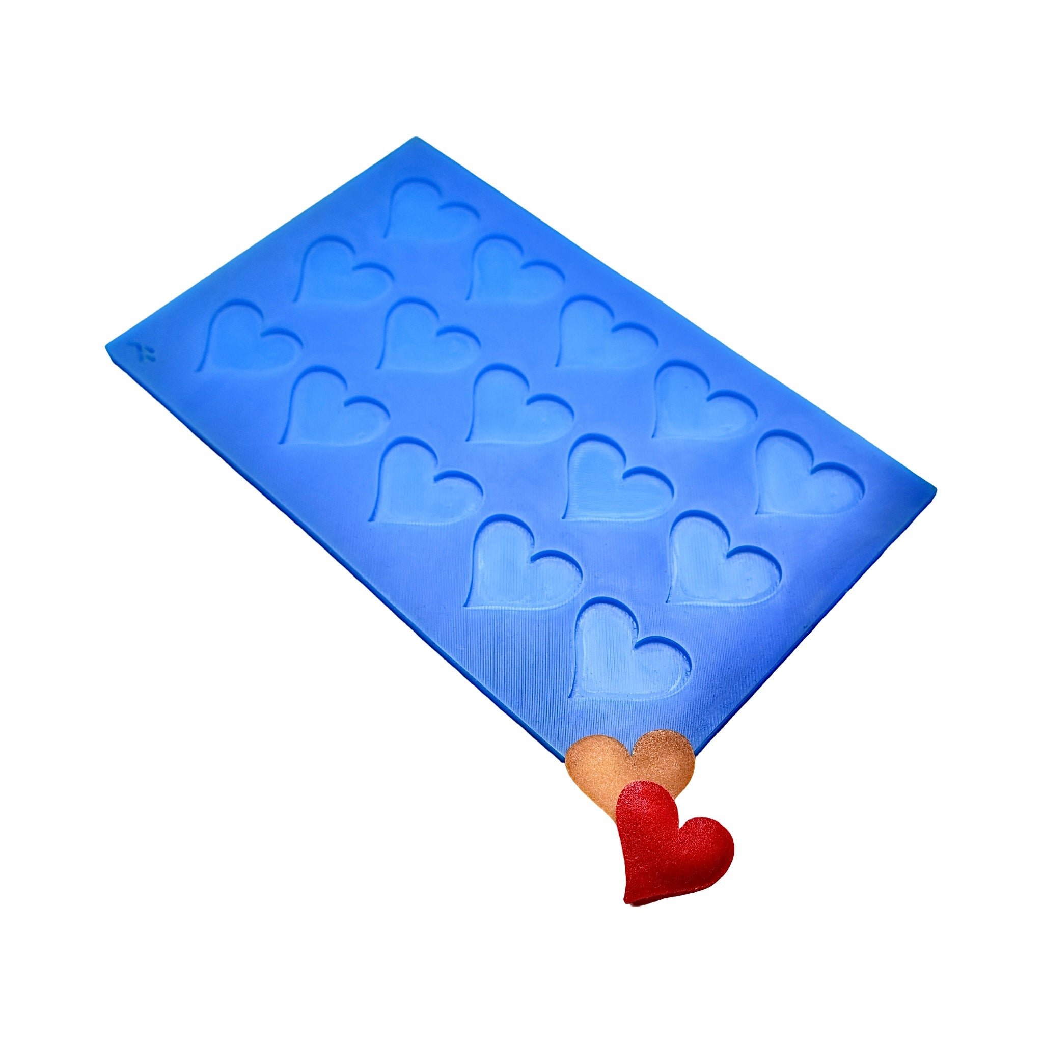 Blue silicone mat with small heart-shaped tuile molds and finished heart decorations.