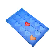 Blue silicone tuile mat featuring small heart-shaped molds with red and gold heart inserts.